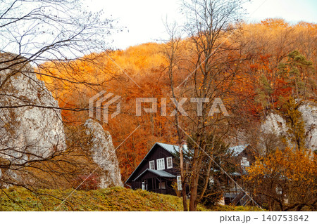 Colors of autumn frame a cabin in the hills during a sunny afternoon in the countryside Colors of autumn frame a cabin in the hills during a sunny afternoon in the countryside 140753842