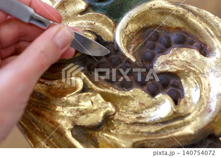 Detailed View of Decorative Wood Carving Showing Intricate Design With Dark and Light Colors in a Close Up Setting Detailed View of Decorative Wood Carving Showing Intricate Design With Dark and Light Colors in a Close Up Setting 140754072