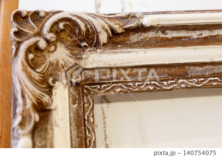 Wooden Frame With Intricate Design Displayed on a Table in a Studio During Daylight Wooden Frame With Intricate Design Displayed on a Table in a Studio During Daylight 140754075