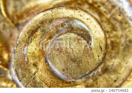 Close View of a Golden Spiral Decoration Showing Signs of Age and Wear in a Detailed Pattern Close View of a Golden Spiral Decoration Showing Signs of Age and Wear in a Detailed Pattern 140754081
