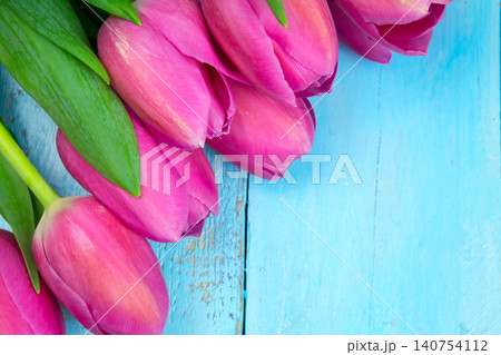 Pink tulips on wooden blue background. Conception holiday, March 8, Mother's Day. Flat lay and copy space Pink tulips on wooden blue background. Conception holiday, March 8, Mother's Day. Flat lay and copy space 140754112