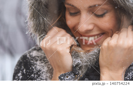 Woman, snow and happy with winter fashion for cold weather and climate in a park in Iceland. Travel, smile and relax female person on a holiday freezing in nature with frost and ice outdoor on trip 140754224