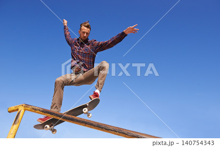 Fitness, energy and man with skateboard, jump or rail balance at a skate park for stunt training. Freedom, adrenaline and gen z male skater with air, sports or skill practice, exercise or performance Fitness, energy and man with skateboard, jump or rail balance at a skate park for stunt training. Freedom, adrenaline and gen z male skater with air, sports or skill practice, exercise or performance 140754343