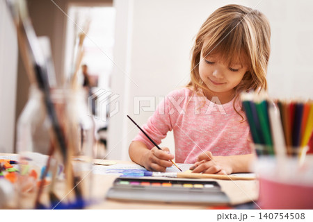 Happy child, drawing and painting with brush for art, craft or color in learning creativity or education at home. Young girl with paintbrush for sketching, writing or artwork in childhood development Happy child, drawing and painting with brush for art, craft or color in learning creativity or education at home. Young girl with paintbrush for sketching, writing or artwork in childhood development 140754508