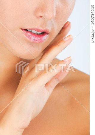 Face, lips and hand with woman touching skin for dermatology, beauty and moisturizer isolated on white background. Facial, balm for mouth with shine and cosmetic care, wellness and skincare in studio Face, lips and hand with woman touching skin for dermatology, beauty and moisturizer isolated on white background. Facial, balm for mouth with shine and cosmetic care, wellness and skincare in studio 140754519