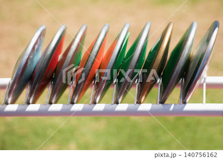 Athletics throw the discus, athletic discs in the rack Athletics throw the discus, athletic discs in the rack 140756162