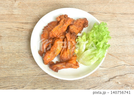 roasted spicy barbecue chicken rib with pepper on plate eat couple fresh lettuce vegetable salad 140756741