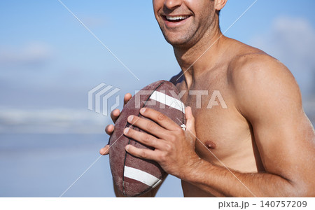 Football, happy man and fitness at the beach on holiday and vacation in Brazil by the sea. Rugby, sport and exercise on the summer of a male person with workout, smile and training outdoor by ocean 140757209