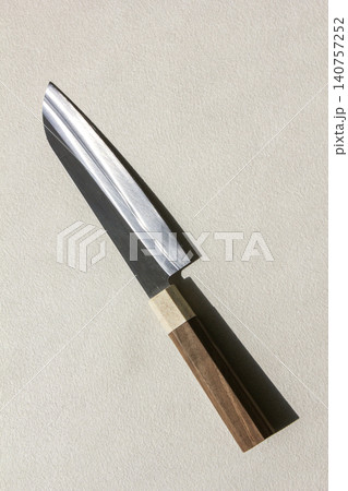 It is a kitchen knife placed against a white background. 140757252