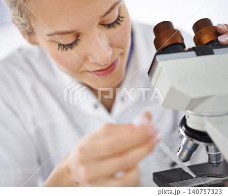 Woman, microscope and drop with test for laboratory research, scientific exam or discovery at clinic. Face of female person or medical expert with smile and scope for science breakthrough or biology 140757323