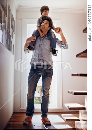 Carry, love or father with child on shoulders in home, house or apartment for support, care or trust. Happy, fun or dad with kid to enjoy family vacation, holiday or holding hands together in England 140757512