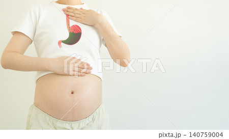 Indigestion and heartburn in pregnancy. Pregnant woman suffering from acid reflux, nausea and bloating due to hormonal changes. Health problems in pregnancy Indigestion and heartburn in pregnancy. Pregnant woman suffering from acid reflux, nausea and bloating due to hormonal changes. Health problems in pregnancy 140759004