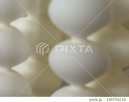 Abstract close-up of white eggs in a carton creating an artistic geometric pattern background 140759238
