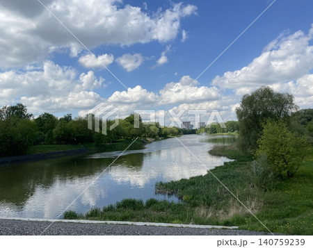 Peaceful river landscape with green trees and cloudy sky, ideal for nature-themed background Peaceful river landscape with green trees and cloudy sky, ideal for nature-themed background 140759239