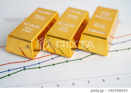 Gold bars on graph paper, finance trading investment business currency. Gold bars on graph paper, finance trading investment business currency. 140760035