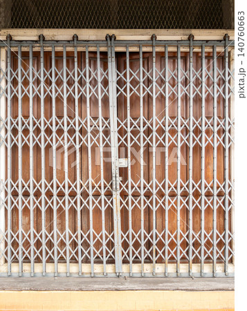 Vintage Thai Shophouse Wooden Doors Behind Folding Steel Security Gate Vintage Thai Shophouse Wooden Doors Behind Folding Steel Security Gate 140760663