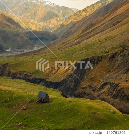 Lonely cabin sits in green valley Lonely cabin sits in green valley 140761201