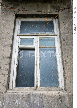 Framed window set in concrete wall, showing neglect and decay 140761692