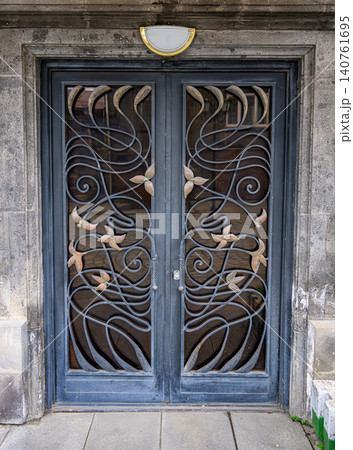 Vintage iron door with floral and sea-themed engravings 140761695