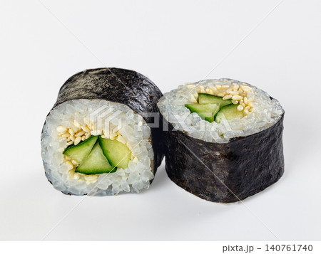 Cucumber sushi rolls with sesame seeds on white background Cucumber sushi rolls with sesame seeds on white background 140761740