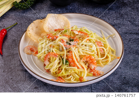 Shrimp and noodle dish with crispy crackers on plate Shrimp and noodle dish with crispy crackers on plate 140761757