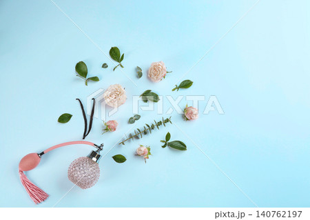 Beautiful composition with bottle of perfume and flowers on white background, flat lay. Space for text Beautiful composition with bottle of perfume and flowers on white background, flat lay. Space for text 140762197