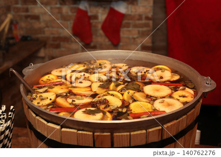 Large cauldron with tasty mulled wine at winter fair Large cauldron with tasty mulled wine at winter fair 140762276