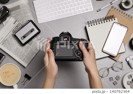 Journalist with camera at grey table, top view Journalist with camera at grey table, top view 140762364