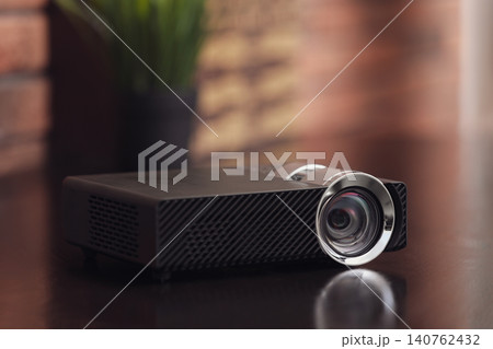 Modern video projector on wooden table indoors 140762432