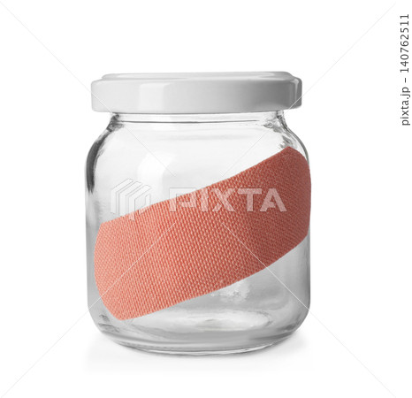 Glass jar with sticking plaster isolated on white Glass jar with sticking plaster isolated on white 140762511