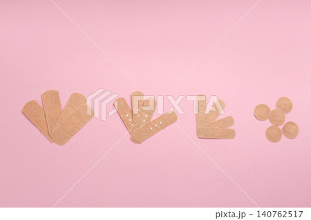 Different types of sticking plasters on pink background, flat lay Different types of sticking plasters on pink background, flat lay 140762517