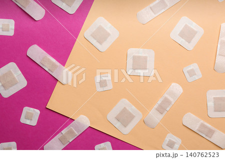 Different types of sticking plasters on color background, flat lay Different types of sticking plasters on color background, flat lay 140762523