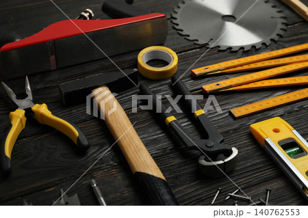Different carpenter's tools on black wooden background Different carpenter's tools on black wooden background 140762553