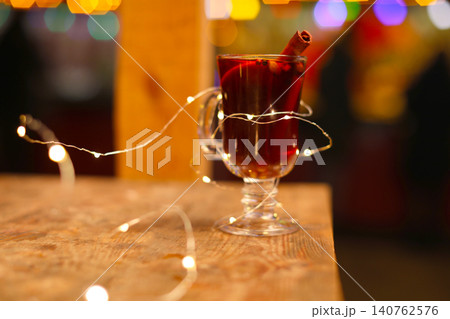 Tasty aromatic mulled wine on table at winter fair Tasty aromatic mulled wine on table at winter fair 140762576