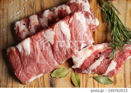 Raw ribs with herbs and spices on wooden table, flat lay 140762615