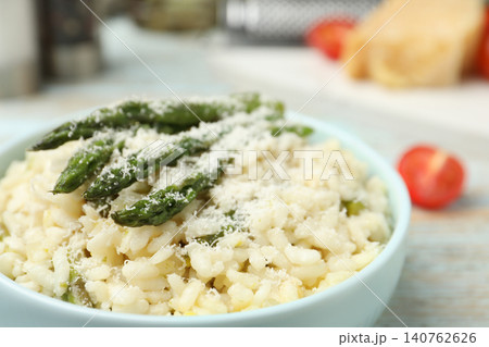 Delicious risotto with asparagus and cheese in bowl, closeup Delicious risotto with asparagus and cheese in bowl, closeup 140762626