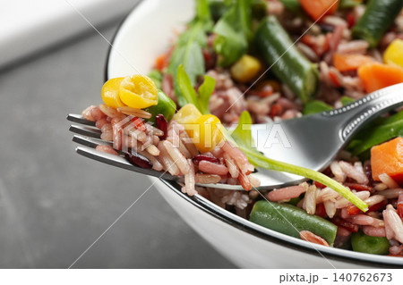 Tasty brown rice with vegetables, closeup view Tasty brown rice with vegetables, closeup view 140762673