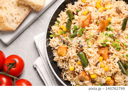 Delicious rice pilaf with chicken and vegetables on light grey table, closeup Delicious rice pilaf with chicken and vegetables on light grey table, closeup 140762799