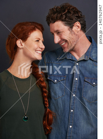 Love, smile and happy couple in studio together with relationship trust, care and support. Romance, casual man and woman embrace on dark background with commitment, loyalty and affection in marriage 140762947