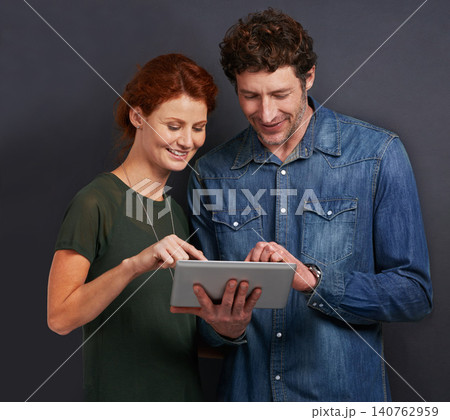 Happy couple, typing and communication with tablet for research or networking on a dark studio background. Young man and woman with smile on technology for online search, browsing or scrolling on app 140762959