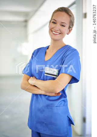 Happy woman, portrait and nurse with confidence in career ambition for healthcare or science at hospital. Young female person, scrub or medical doctor with smile or arms crossed for PHD at the clinic Happy woman, portrait and nurse with confidence in career ambition for healthcare or science at hospital. Young female person, scrub or medical doctor with smile or arms crossed for PHD at the clinic 140763237