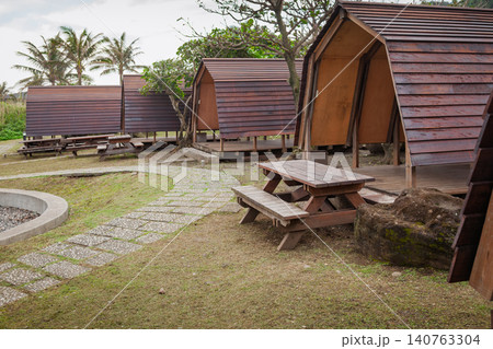 Wooden camping shelters beside a seaside path Wooden camping shelters beside a seaside path 140763304