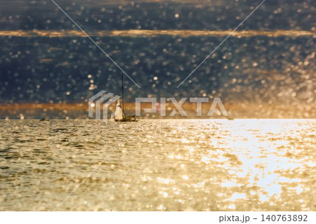 Vintage sailing boat through splashing water at sunset, Sailing regatta in the Gulf of Finland at sunset, hot race of several yachts, teamwork 140763892