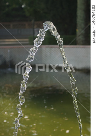 Water jet forming an arch in a park 140764182