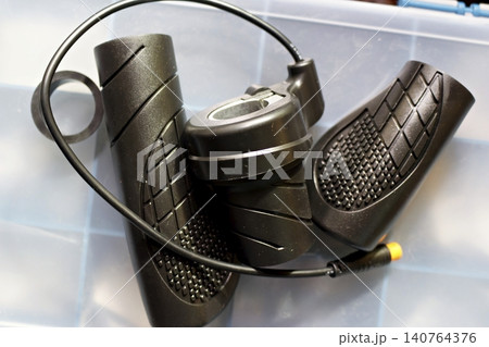 New black rubber grips and throttle assembly for an electric bike, featuring ergonomic textured design and wired connector, perfect for custom e-bike upgrade and repair projects New black rubber grips and throttle assembly for an electric bike, featuring ergonomic textured design and wired connector, perfect for custom e-bike upgrade and repair projects 140764376