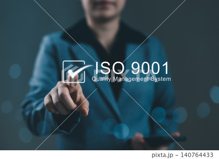 ISO 9001 Quality Management System Concept. Businesswoman pointing to ISO 9001 quality management system icon, representing certification standards, business excellence, ISO certified, standardization 140764433
