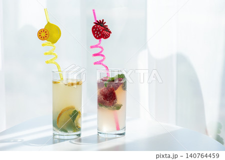Refreshing drinks with lemon and strawberry in glasses Refreshing drinks with lemon and strawberry in glasses 140764459