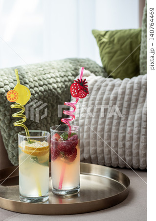 Refreshing summer drinks with fruity straws on a tray Refreshing summer drinks with fruity straws on a tray 140764469
