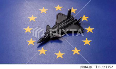 A fighter jet on the European Union flag as a conceptual backdrop representing Europe's defense 140764492