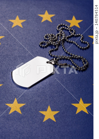 A dog tag on the European Union flag, serving as a conceptual backdrop A dog tag on the European Union flag, serving as a conceptual backdrop 140764514